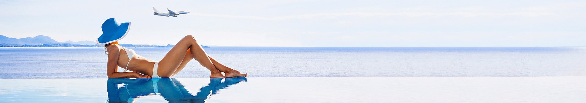 Woman relaxing by an infinity pool overlooking the sea with a plane flying above | MSC Cruises