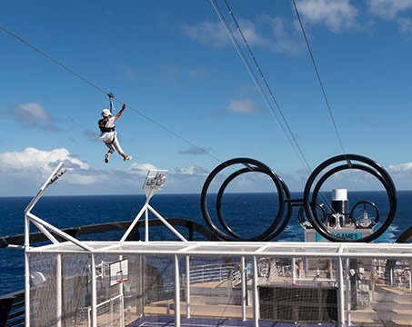 A guest ziplining on an MSC cruise ship with ocean views | MSC Cruises