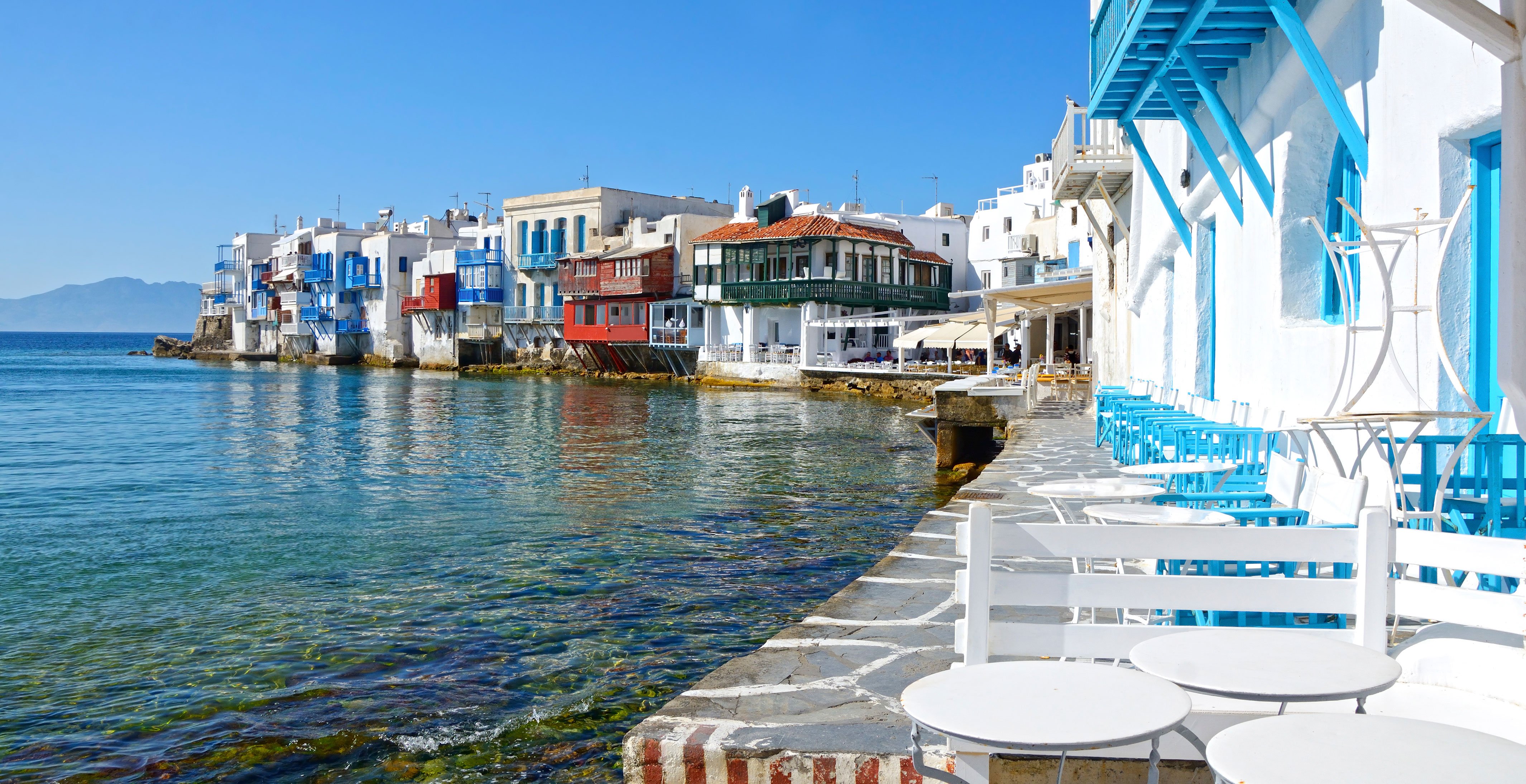 Colorful waterfront houses and outdoor seating in Mykonos, Greece, by the Aegean Sea | MSC Cruises