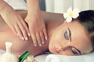 Hands performing a relaxing spa massage with tropical decor | MSC Cruises Hands performing a relaxing spa massage with tropical decor | MSC Cruises