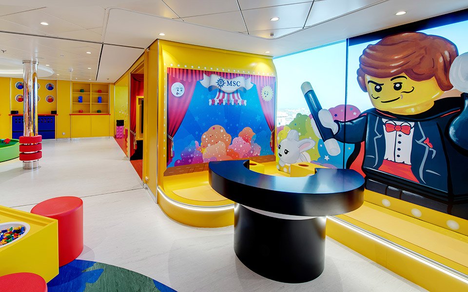 Colorful LEGO-themed kids' playroom with magic show decor on an MSC cruise ship | MSC Cruises Colorful LEGO-themed kids' playroom with magic show decor on an MSC cruise ship | MSC Cruises