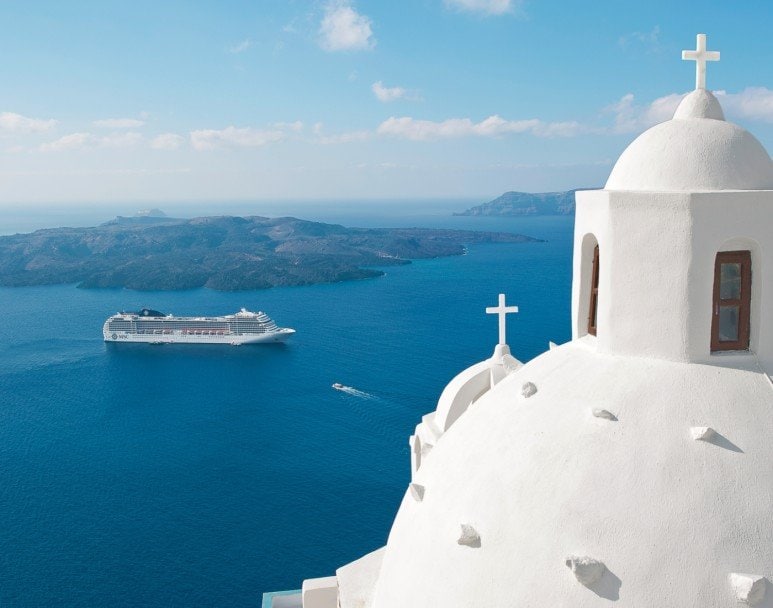 An MSC cruise ship near Santorini's iconic white domes and blue sea | MSC Cruises