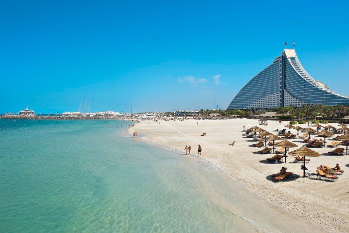 A pristine beach with a luxury hotel and calm turquoise waters | MSC Cruises