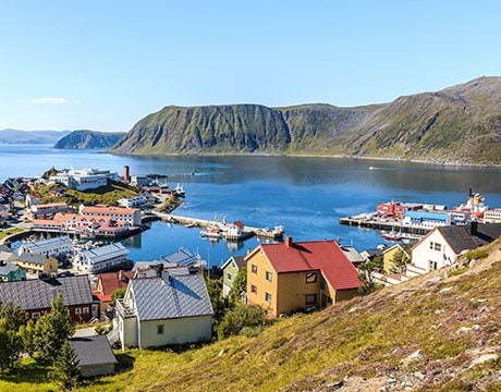 A picturesque coastal village with colorful houses and a fjord backdrop | MSC Cruises A picturesque coastal village with colorful houses and a fjord backdrop | MSC Cruises