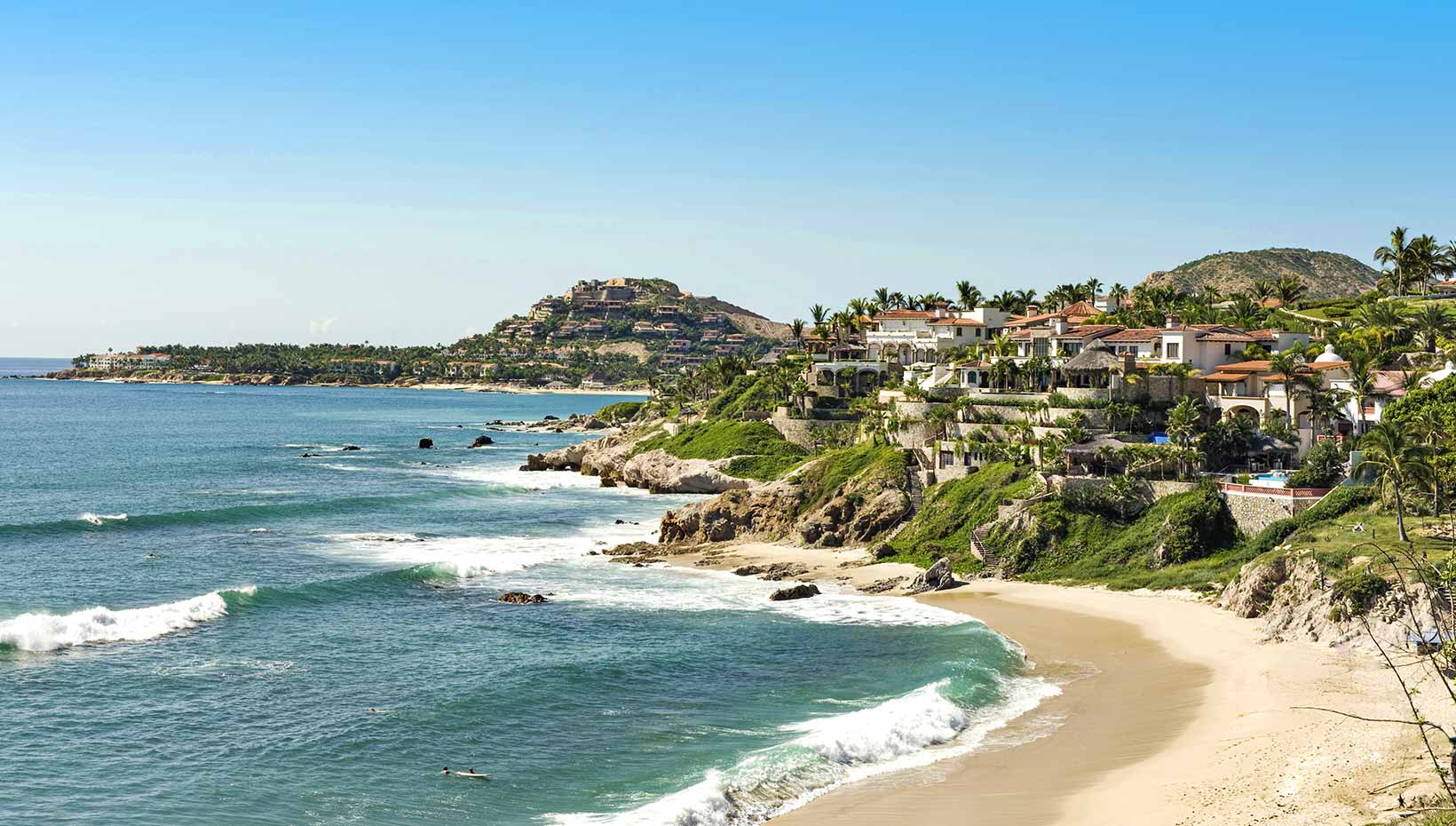 Scenic coastline with luxury villas and sandy beach in a tropical destination | MSC Cruises