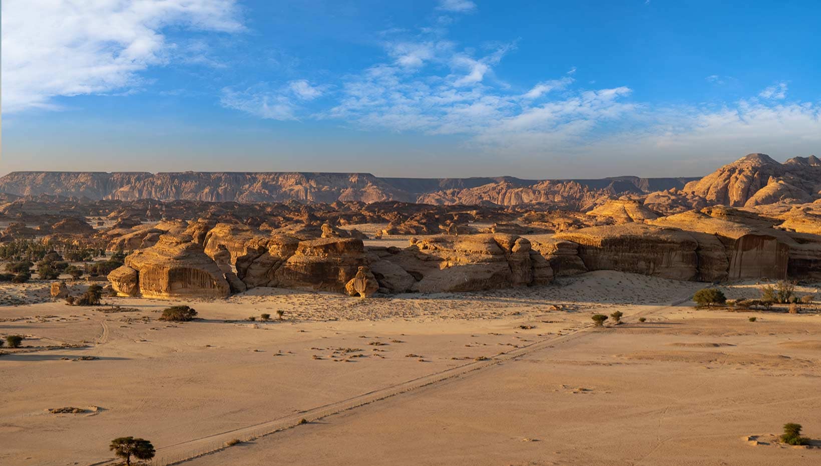 Stunning desert landscape with rocky formations under a bright blue sky | MSC Cruises Stunning desert landscape with rocky formations under a bright blue sky | MSC Cruises