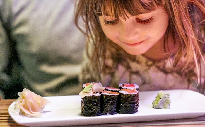 A plate of sushi rolls with wasabi and pickled ginger served onboard | MSC Cruises