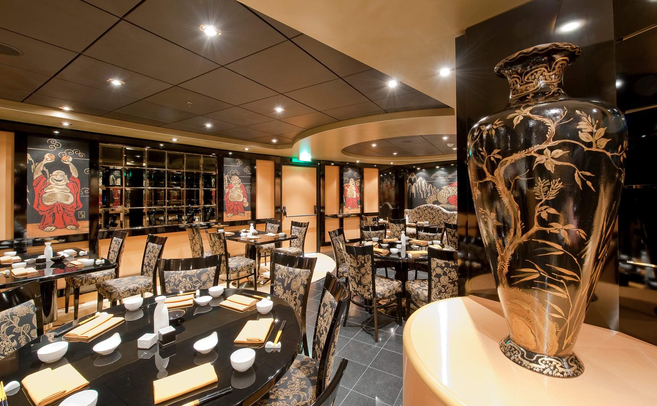 Elegant Asian-themed restaurant onboard with intricate decor and dining tables set for guests | MSC Cruises